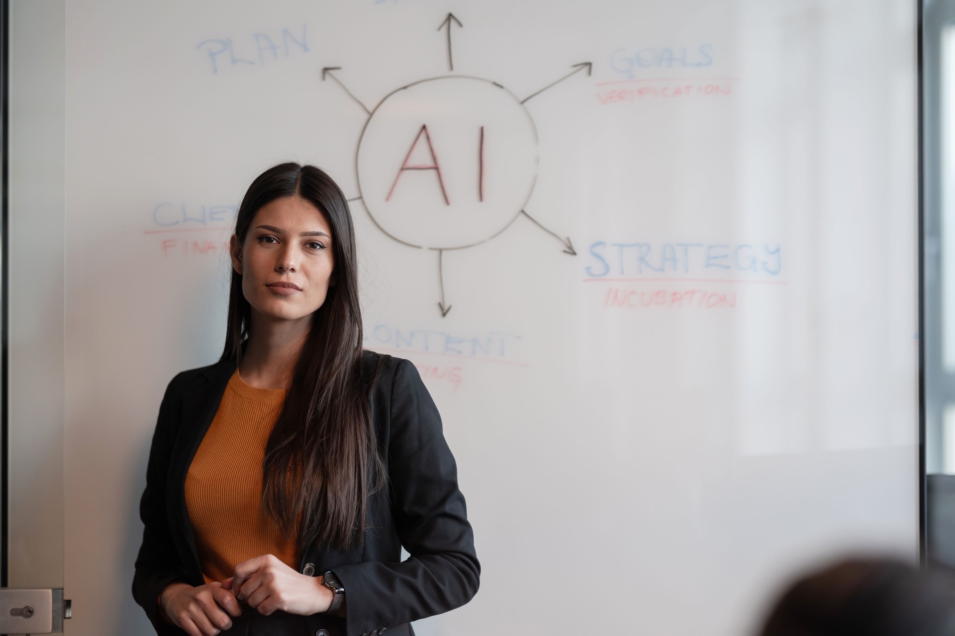 Confident businesswoman or consultant presenting AI strategy on a whiteboard in a corporate setting. Concept of artificial intelligence, leadership, and professional development